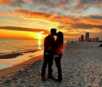 couples on the beach at sunset in Gulf Shores