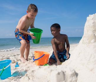 Kids building sandcastles in Gulf Shores, AL