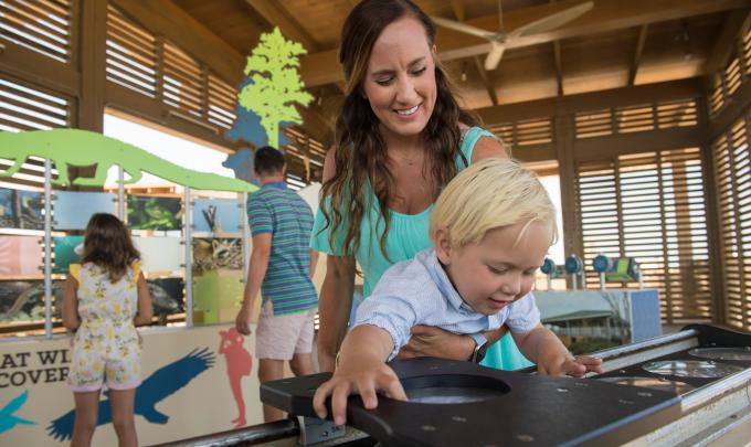 Mother and son exploring the Interpretive Center at Gulf State Park