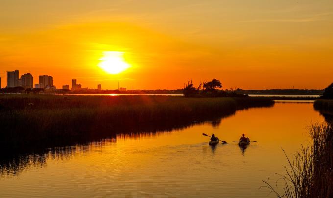 Couple kayaking at sunset in Gulf Shores, AL