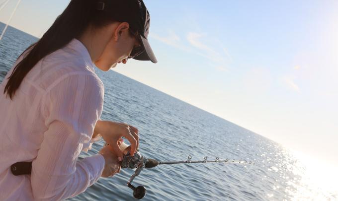 Woman offshore fishing on the Alabama Gulf Coast