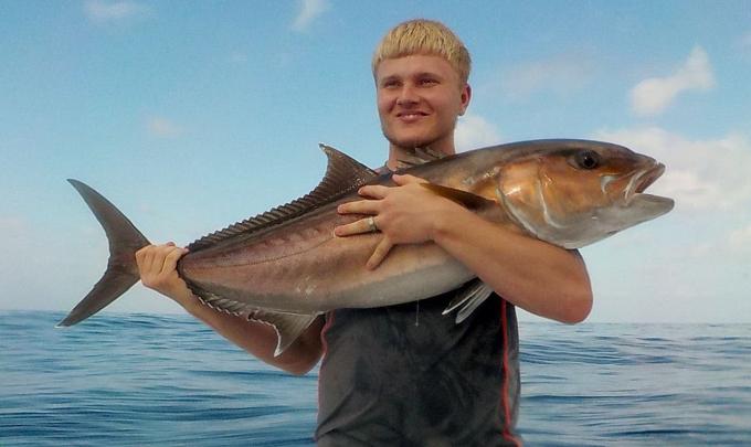 Angler holding an amberjack caught in the Gulf of Mexico