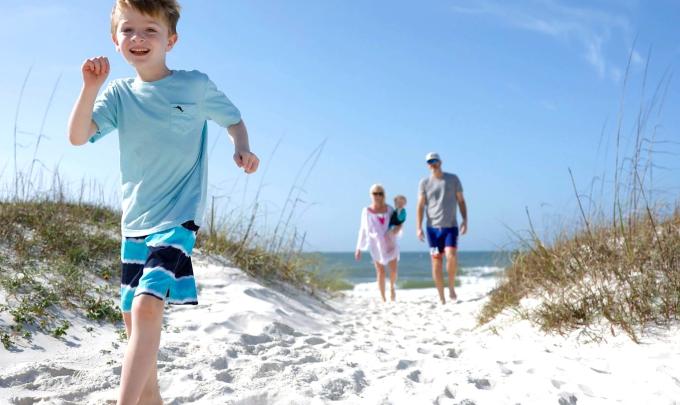 Family running on beach