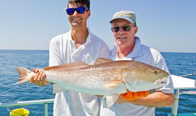 Anglers with a redfish caught in Orange Beach
