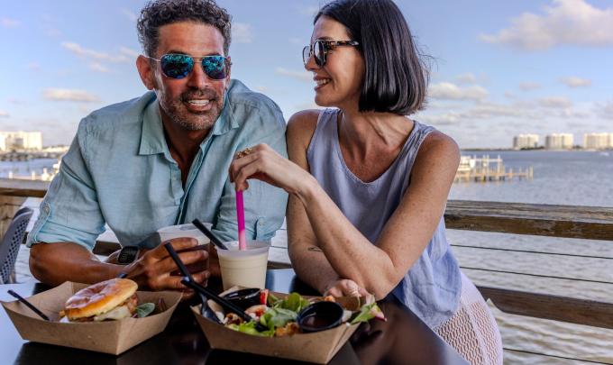 Couple dining at Avenue Pub waterfront restaurant in Orange Beach