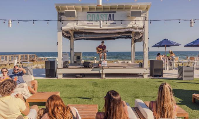 People listening to live music at Coastal beachfront restaurant in Orange Beach