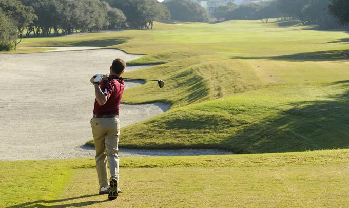 Golfer swinging at Kiva Dunes Golf Resort in Fort Morgan
