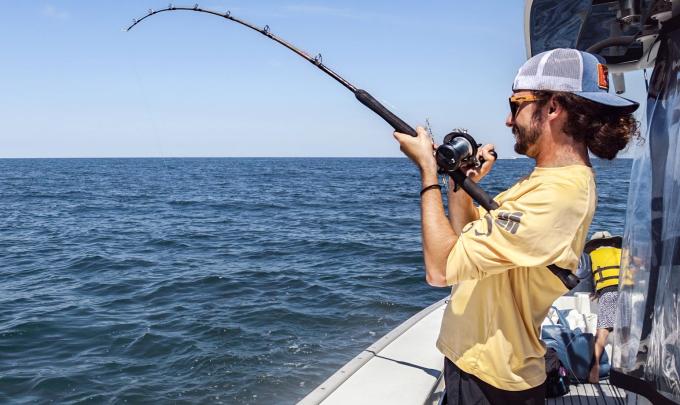 Man fishing off the side of an offshore charter in Orange Beach