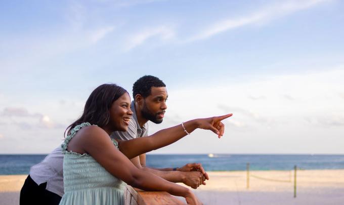 Couple on a boardwalk at the beach during sunset in Orange Beach