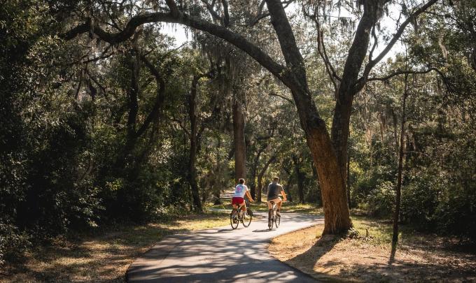 Couple biking along the paved trails in Gulf State Park in Orange Beach