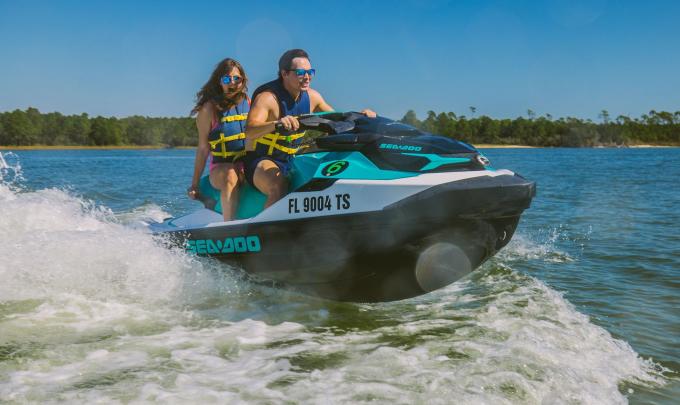 Couple riding a Jet Ski across the water in Orange Beach