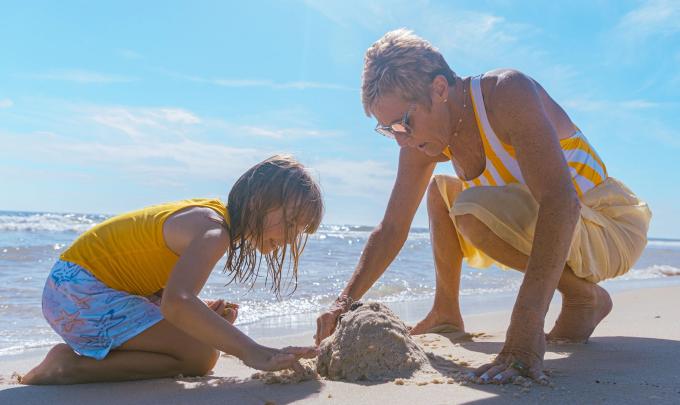 grandma and grandkid playing on the beach in gulf shores