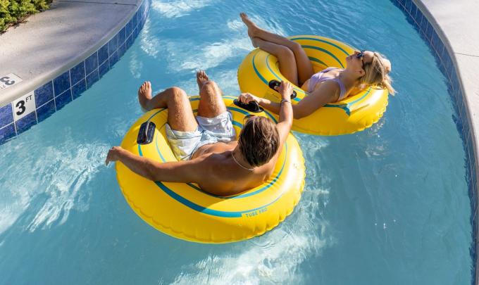Couple floating on a lazy river at Phoenix West beachfront condo in Orange Beach