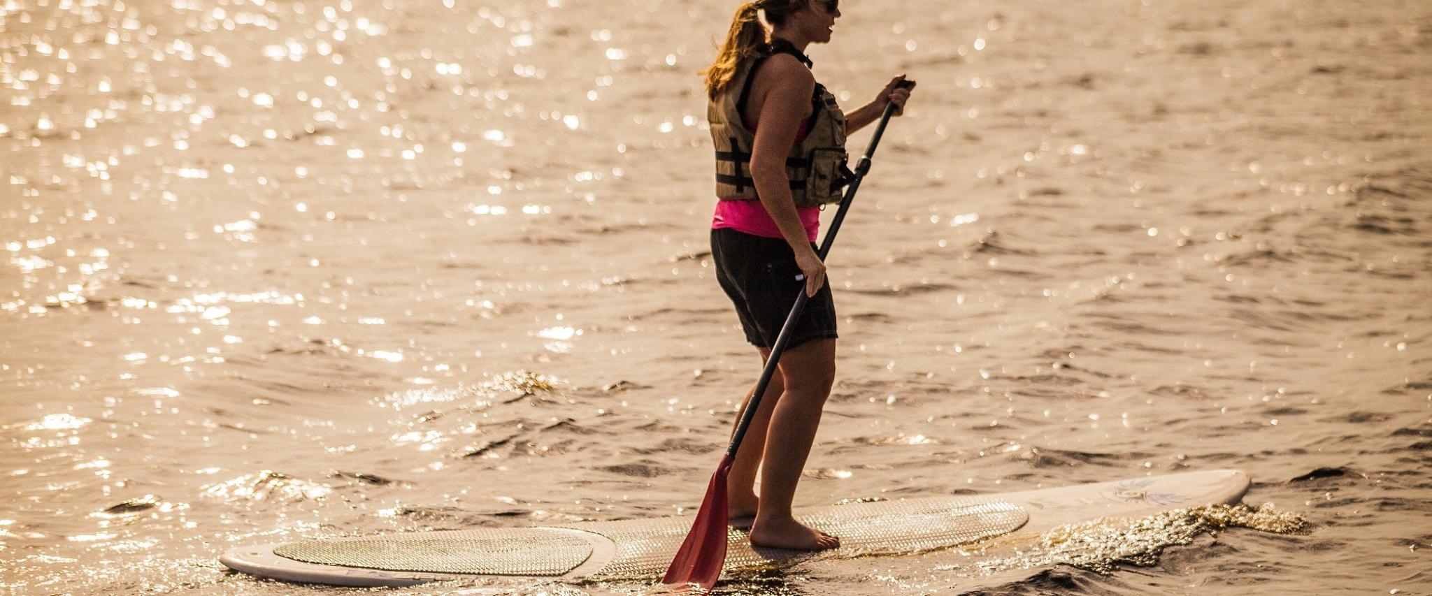 paddleboarding at sunset in Orange Beach AL