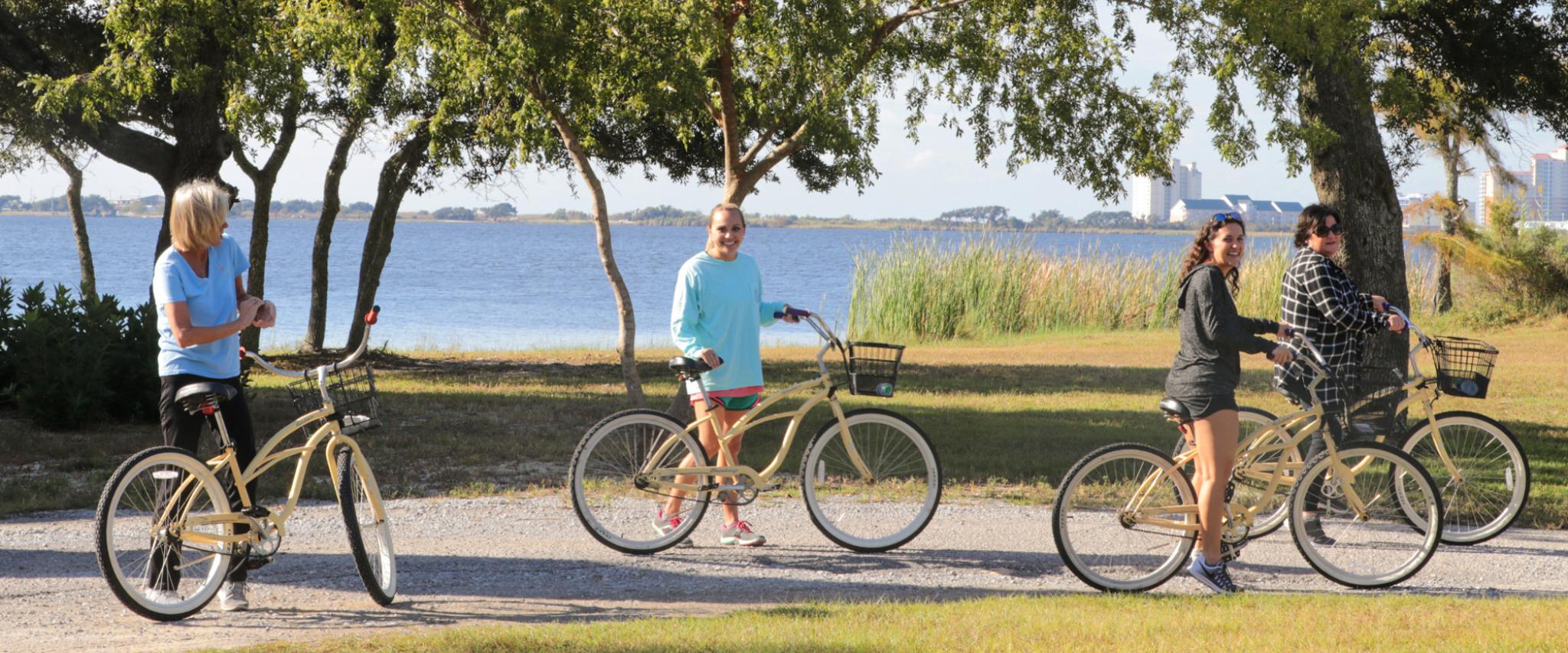 women biking on Hugh S Branyon Backcountry Trail in Orange Beach