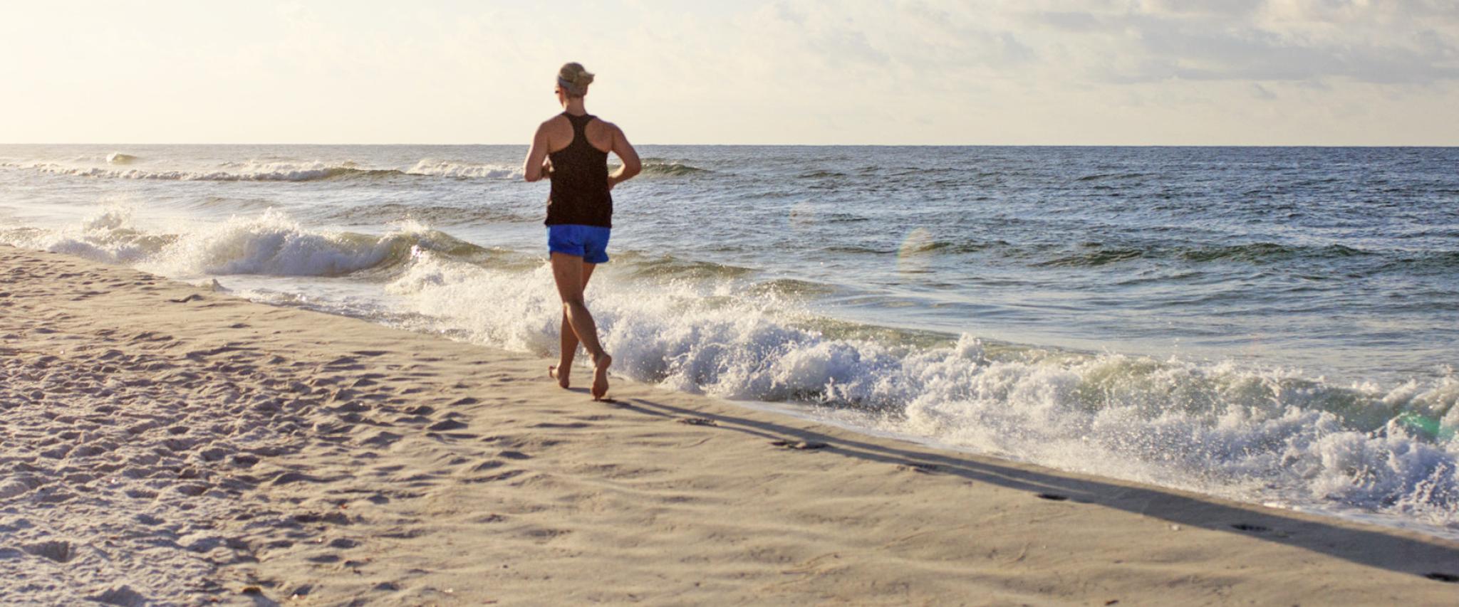 Woman running on Alabama's white sand beaches