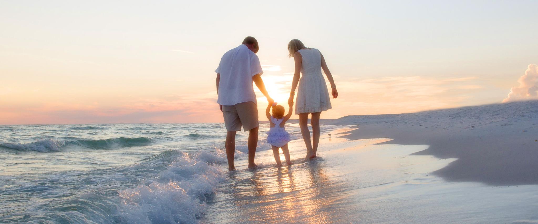 Young Family walks along Alabma's beaches at Sunset