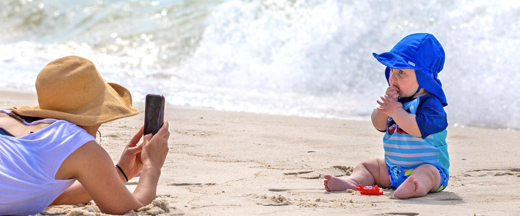 Mom taking pictures of son on Alabama's Beaches