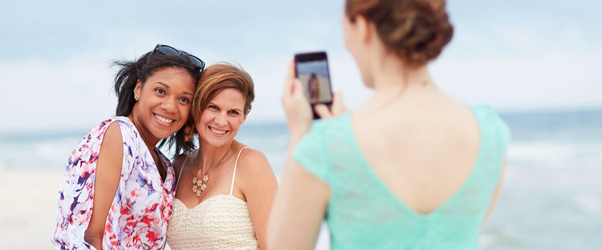 Friends take photos on Alabama's Beaches