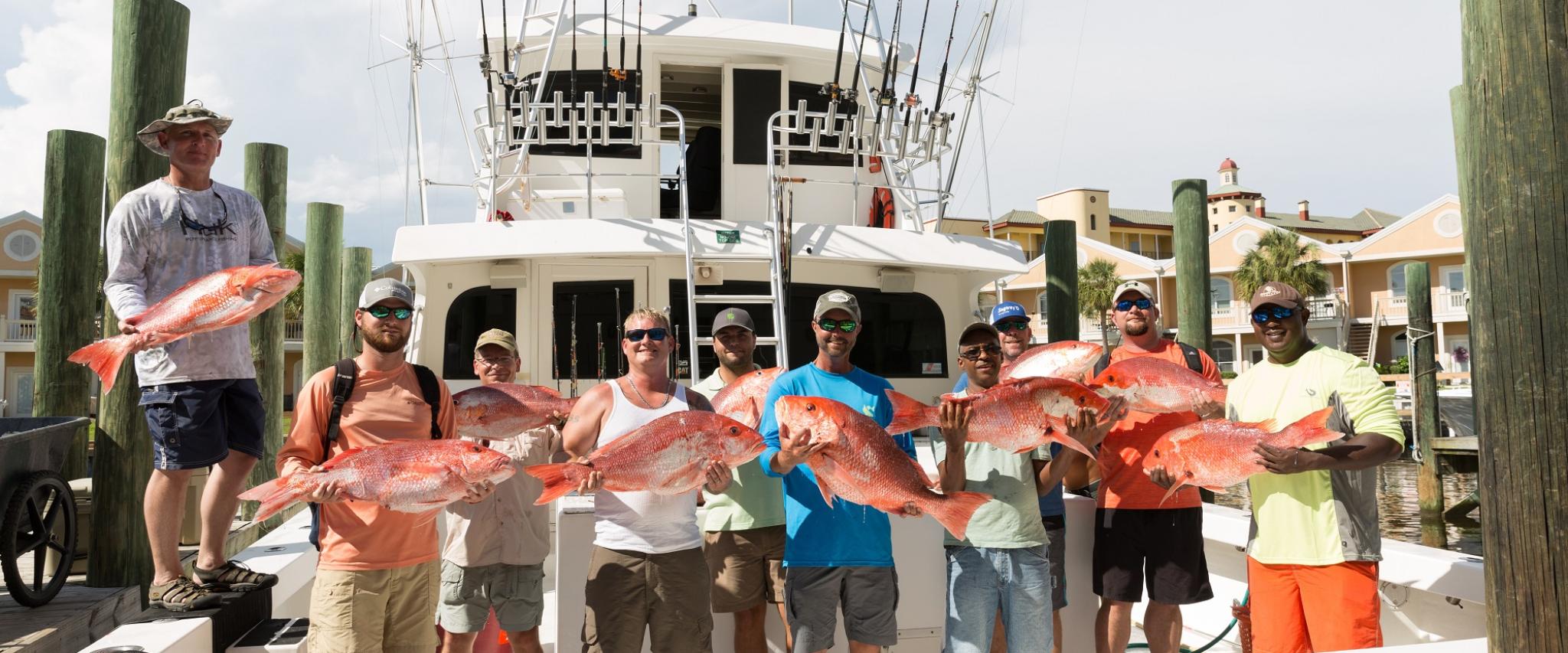 group shot of men on fishing boat with their catch Orange Beach