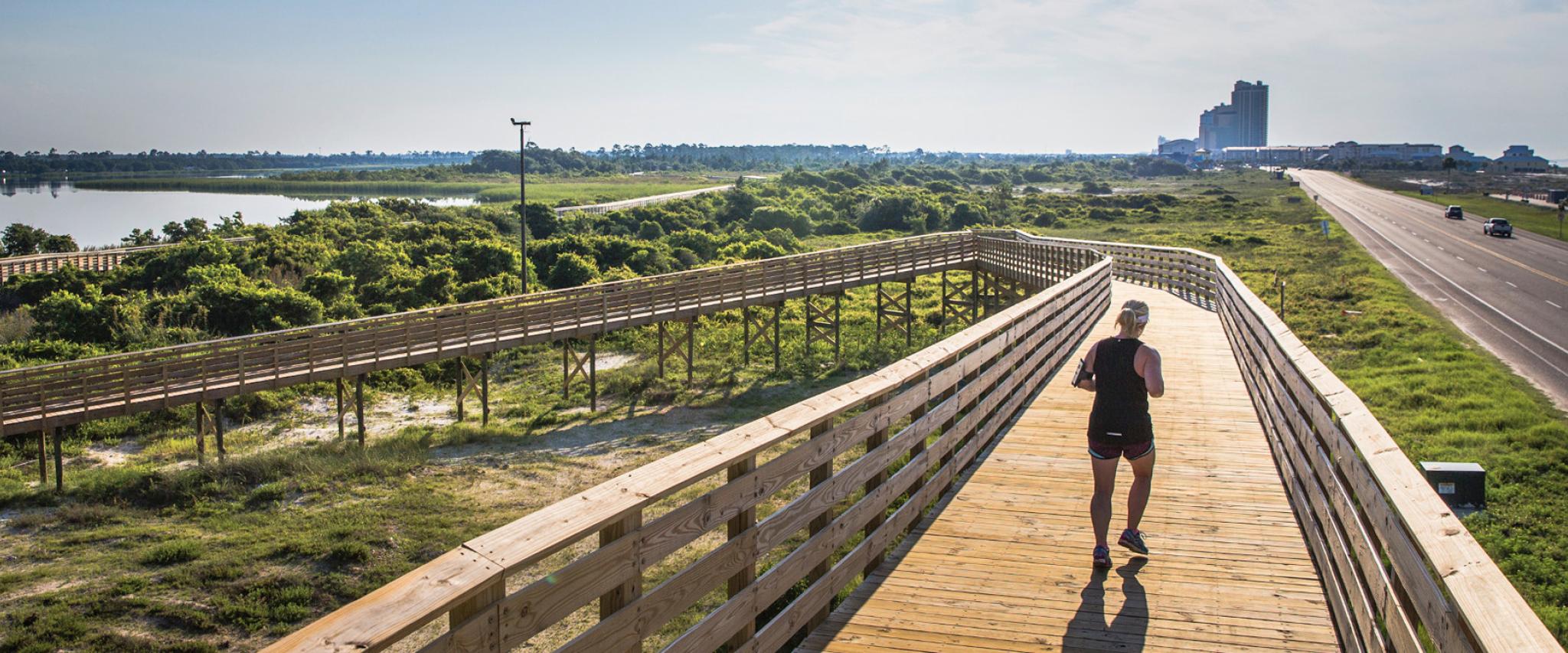 Woman running near Gulf State Park in Alabama