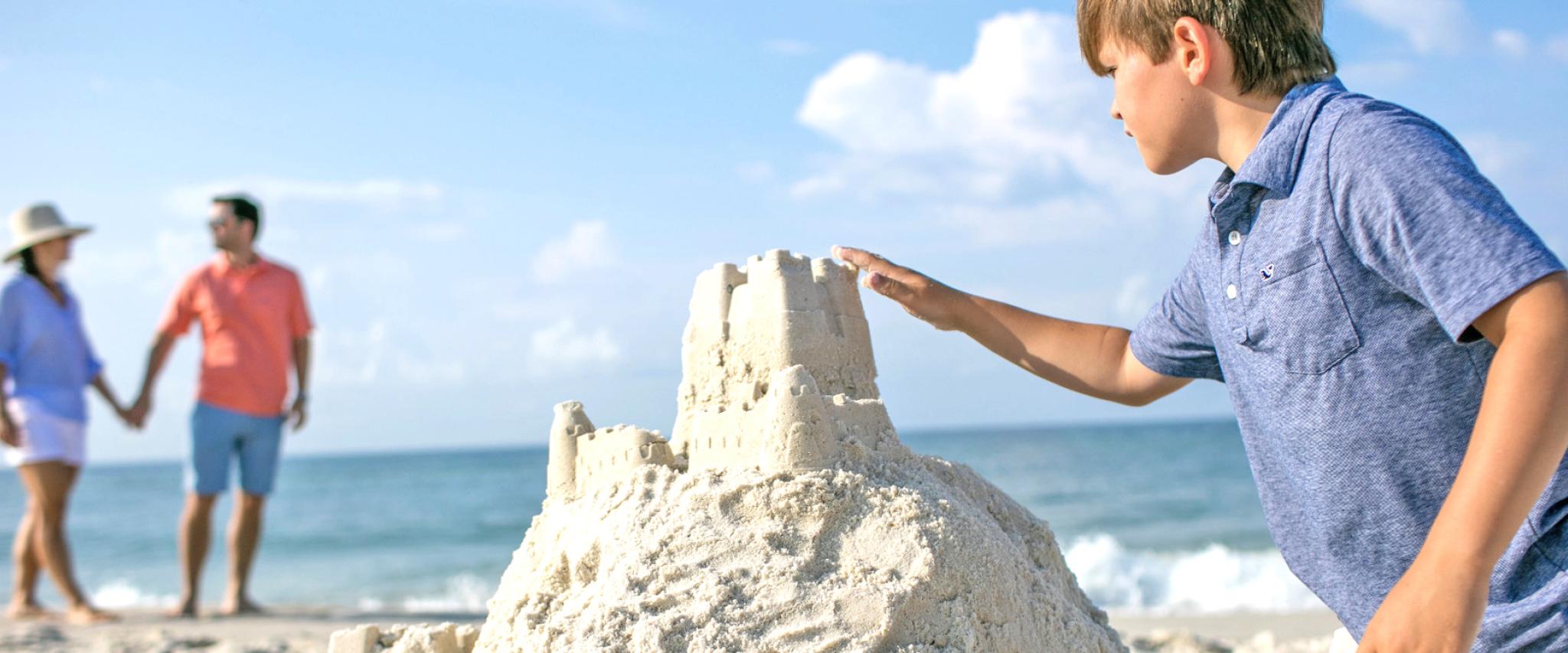 Boy building sand castle on Alabama's Beaches