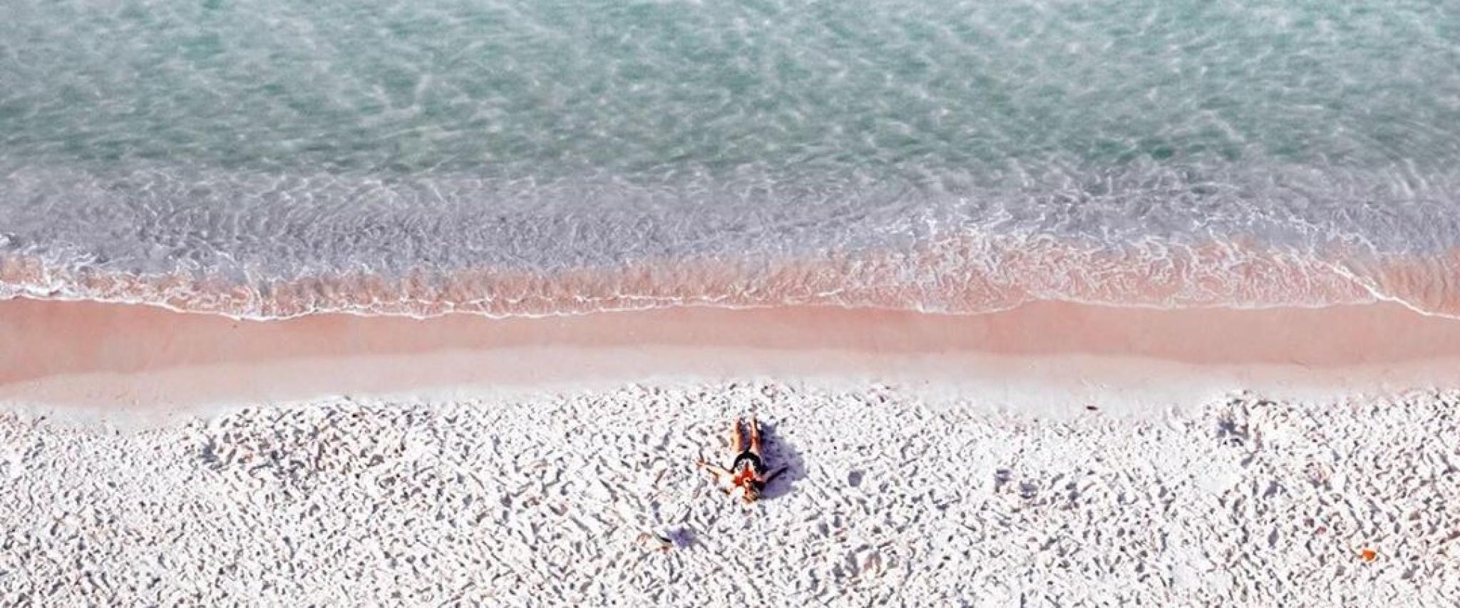 Woman relaxing on the beach in Orang Beach, AL