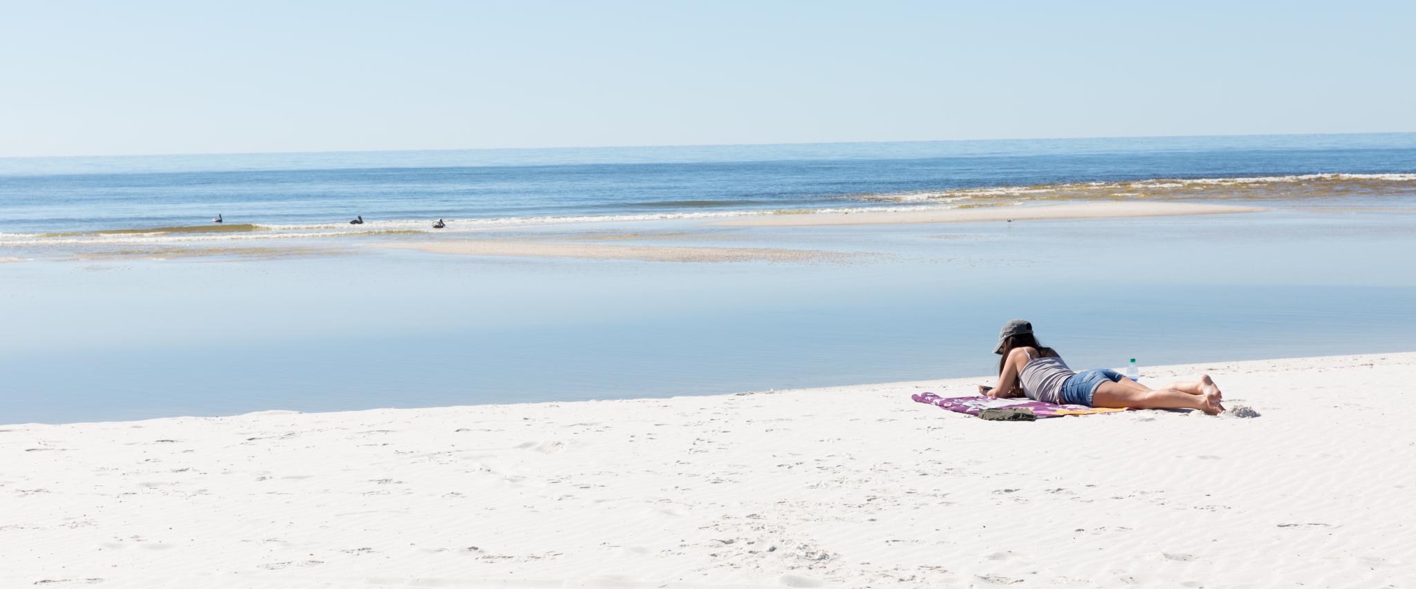 reading on the beach, gulf shores, orange beach