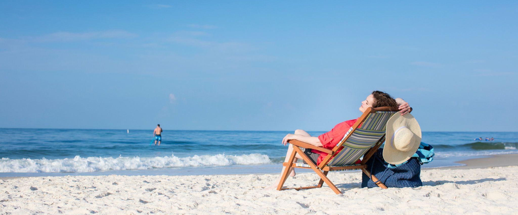 Woman lounging on the beach in Orange Beach, AL