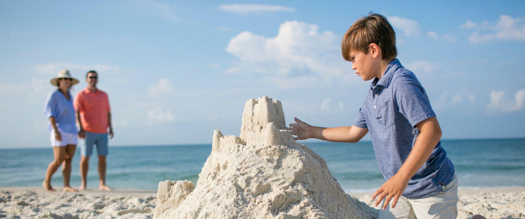 Young boy building sandcastle in Orange Beach, AL