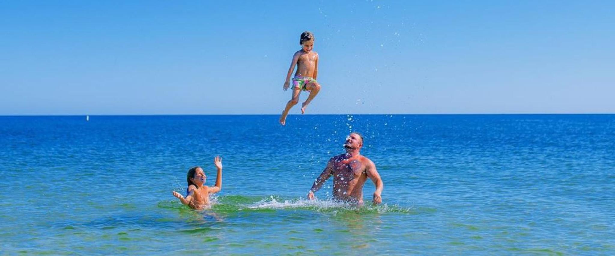 Family in the water in Orange Beach, AL