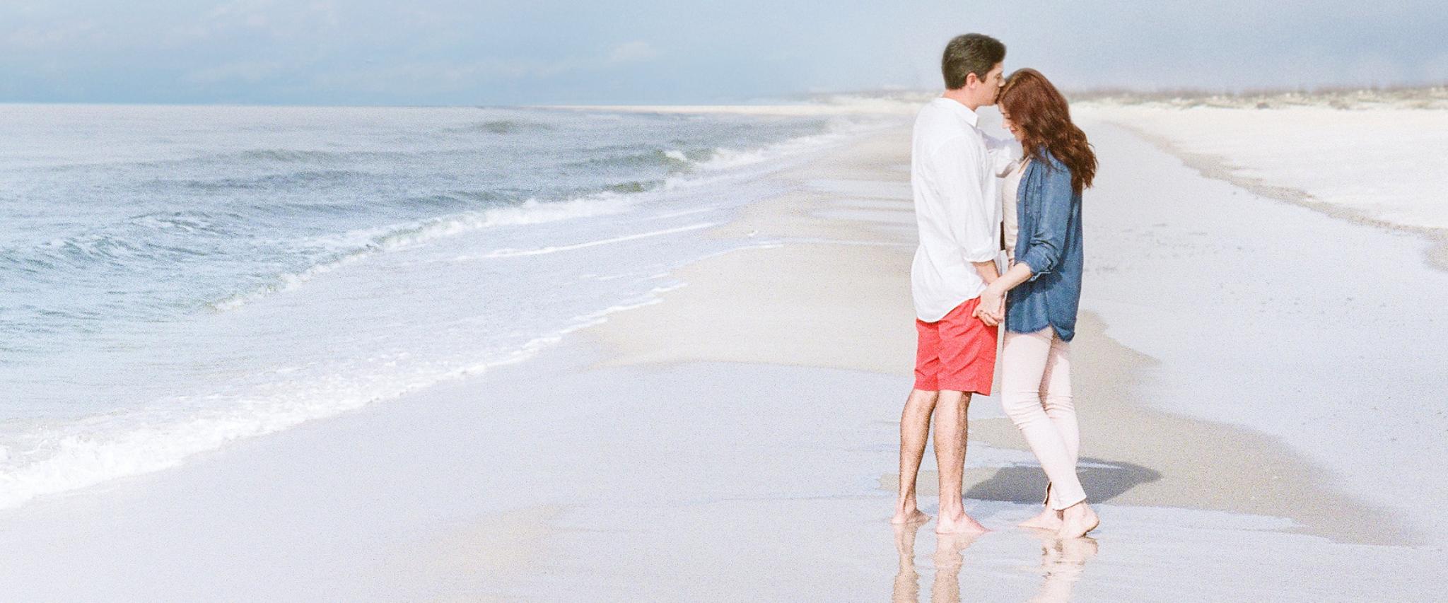 Couple holding hands on Alabama's Beaches