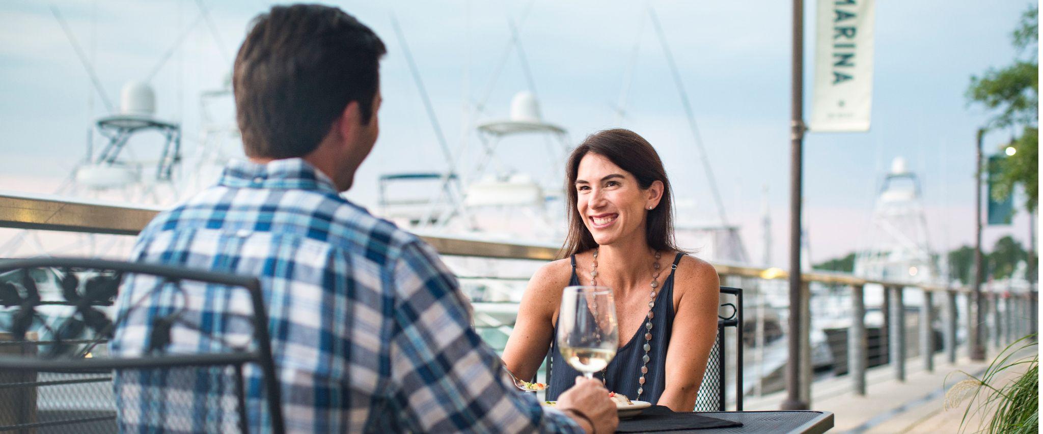 couple drink wine at The Wharf Orange Beach AL