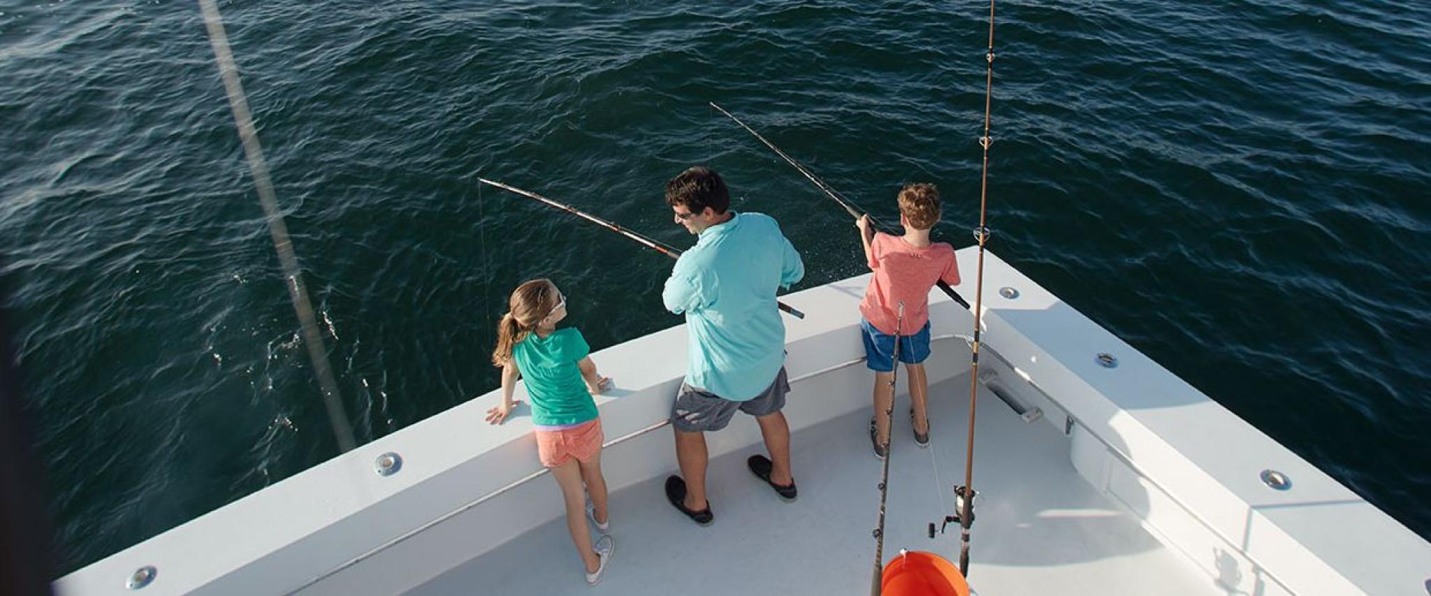 Dad and kids fishing in Orange Beach, AL