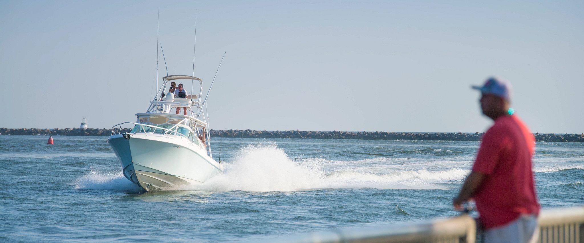 Man watching large boat come into Orange Beach, AL