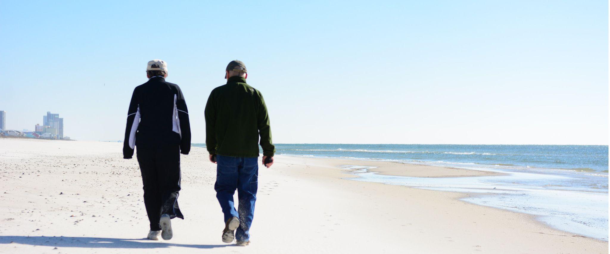 Snowbirds walking on the beach in Gulf Shores, AL