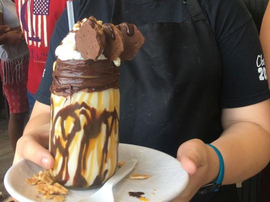 Waitress holding milkshake on plate