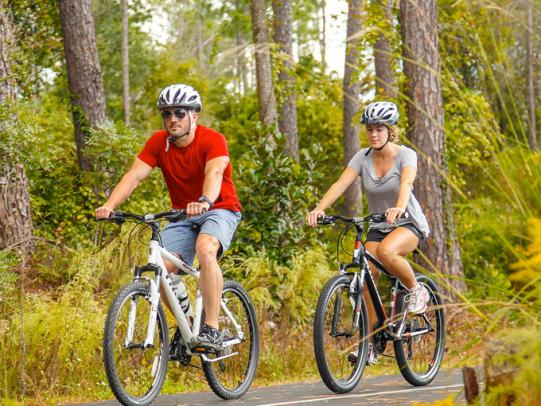 Couple riding bikes in Orange Beach