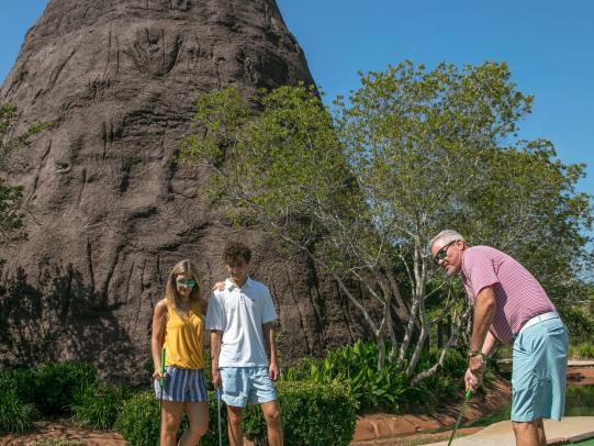 Family playing mini golf in Orange Beach, AL