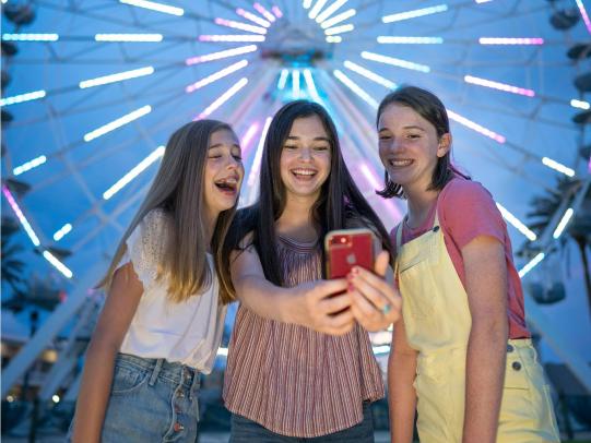 Teens taking selfies at The Wharf in Orange Beach, AL