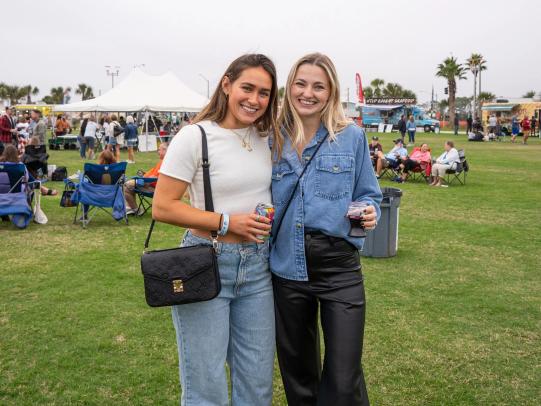 Women holding drinks at The  Coastal Alabama Food Truck & Craft Beer Festival, free food festival in Gulf Shores
