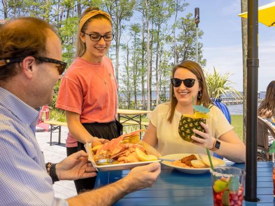 Couple dining at GTs on the Bay waterfront restaurant in Orange Beach