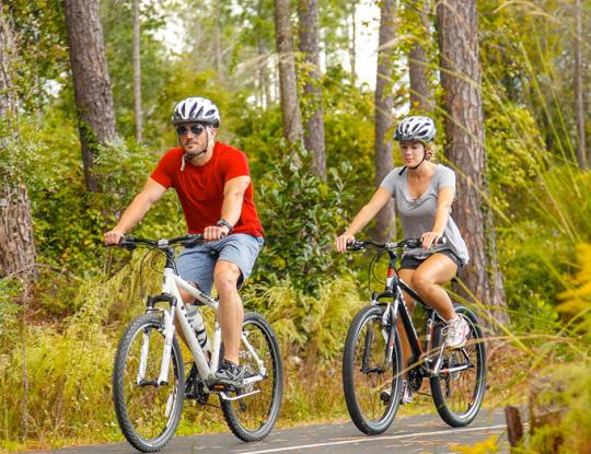 Couple riding bikes in Orange Beach