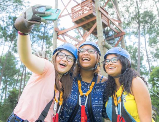 Girls take selfie at 5. Hummingbird Zip Line Course