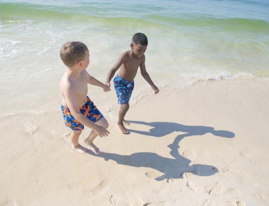 Kids playing on the beach at Gulf State Park