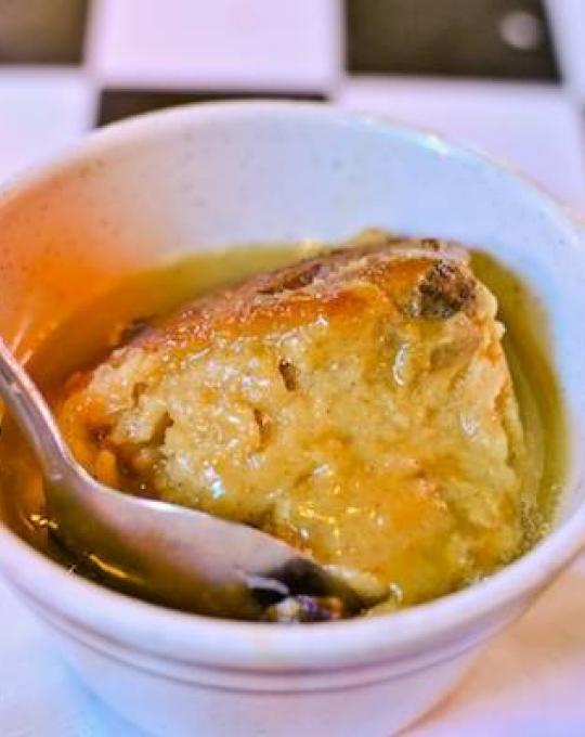 Bread pudding in a cup with a spoon