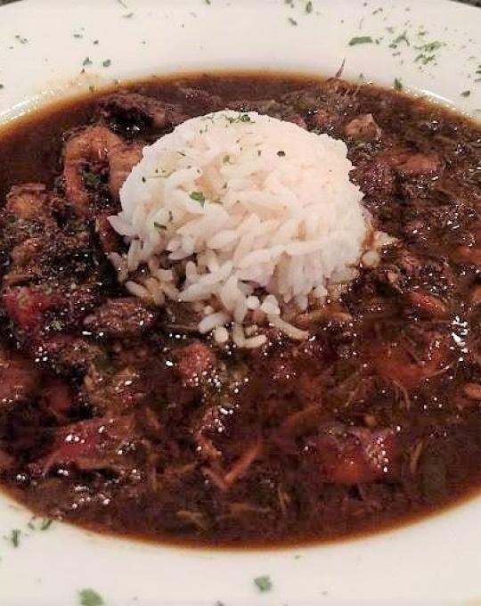 Bowl of gumbo with a scoop of rice