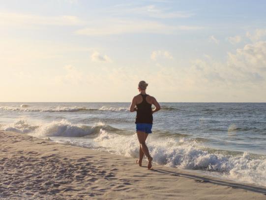Woman running on Alabama's white-sand beaches