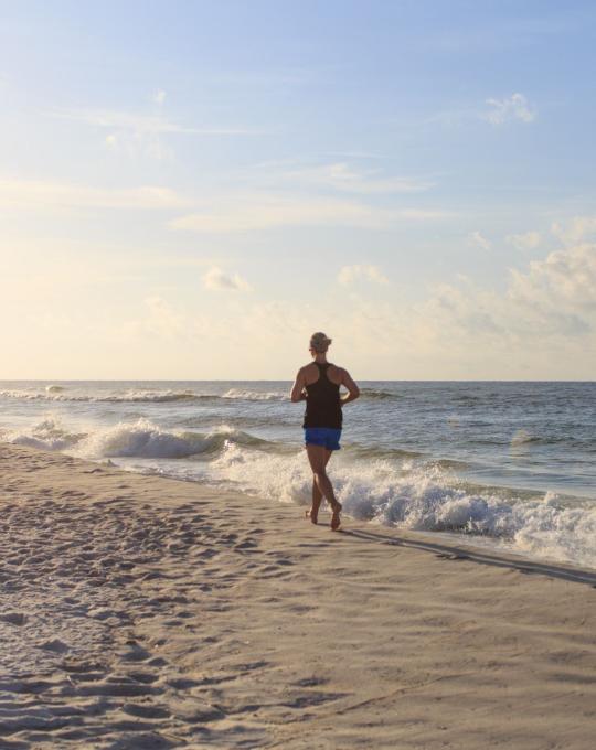 Woman running on Alabama's white-sand beaches