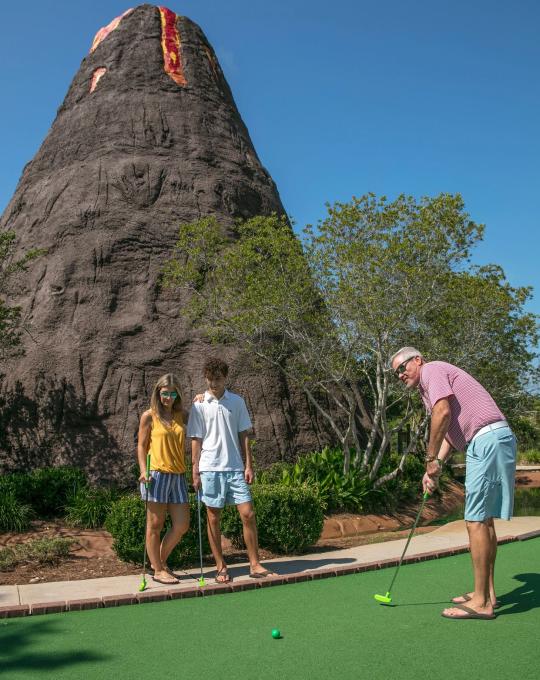 Family playing mini golf in Orange Beach, AL